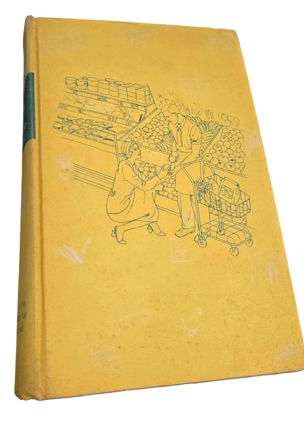A vintage hardcover book with a yellow cover featuring a blue line art illustration of a figure holding a staff, resting on a dark wooden shelf.