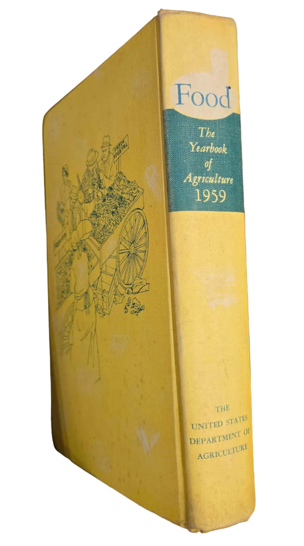 A vintage hardcover book titled 'The Yearbook of Agriculture 1959' with a yellow cover and a teal spine band, photographed resting on a wooden shelf.